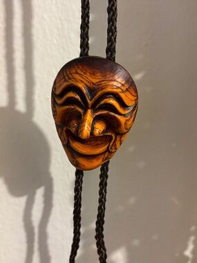 Carved Smiling Mask Necklace in Warm Amber Tone